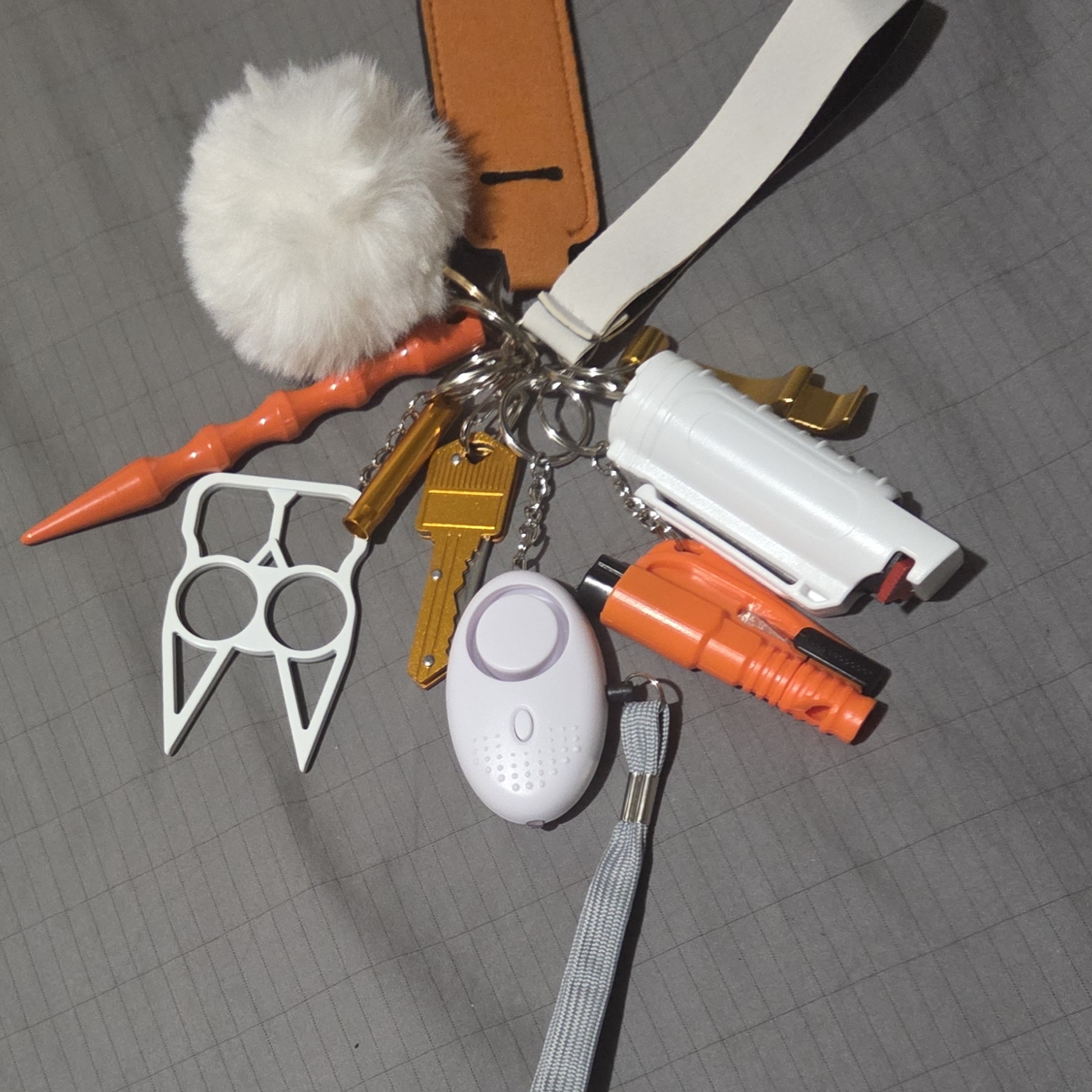 Orange Cream Keychain With Safety Gadgets And Accessories